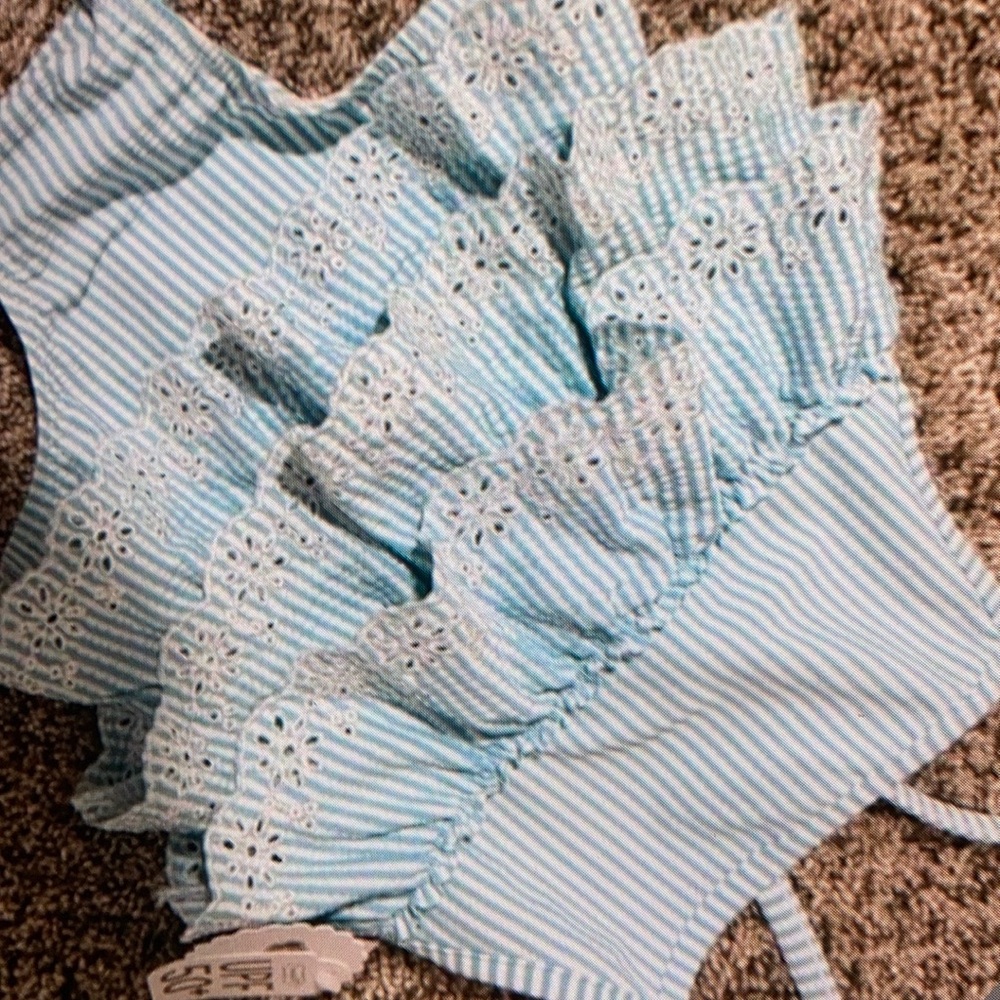Features ruffle accents one piece